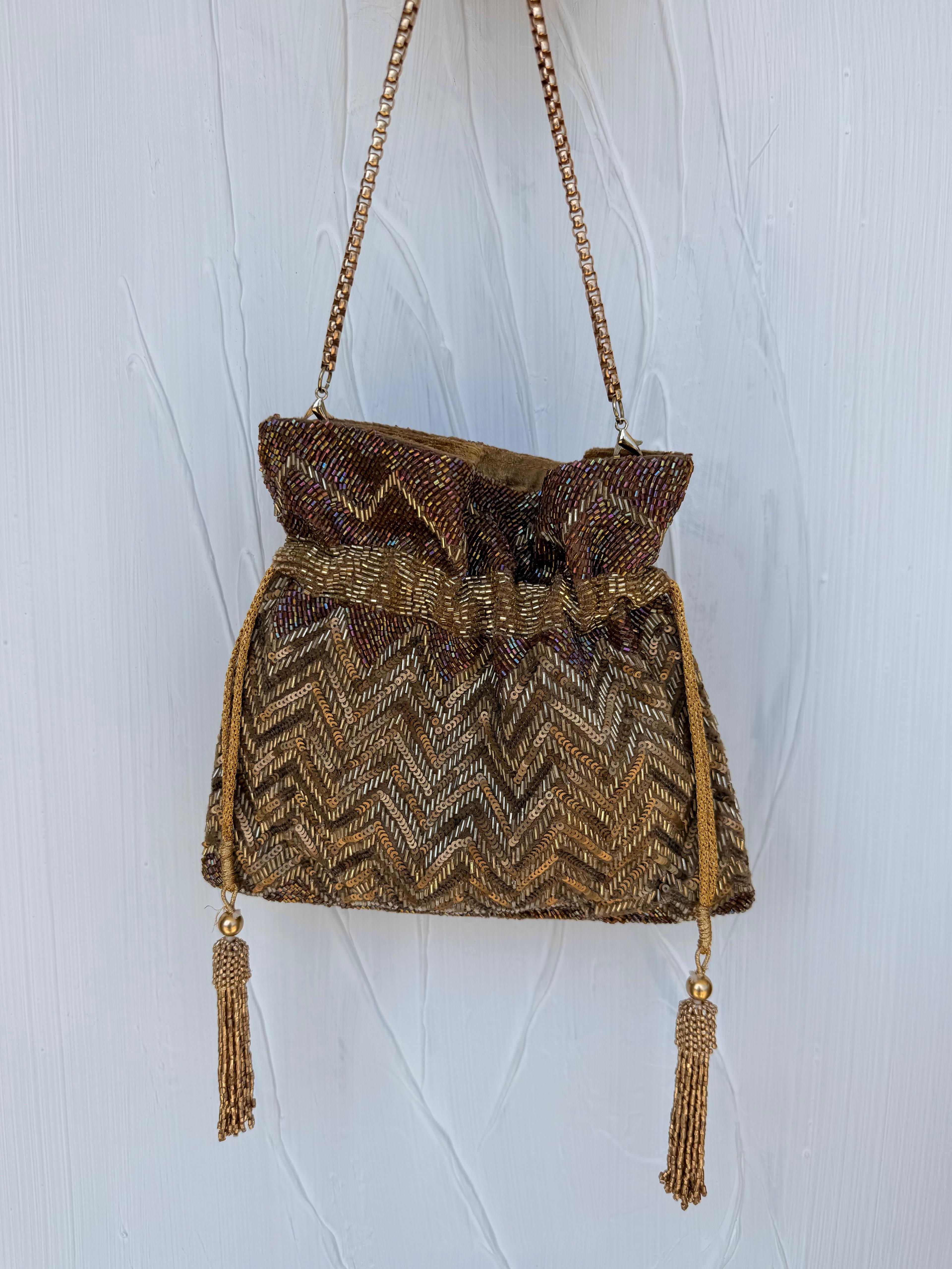 Gold bronze Indian Potli bag with chevron beading and tassel detail