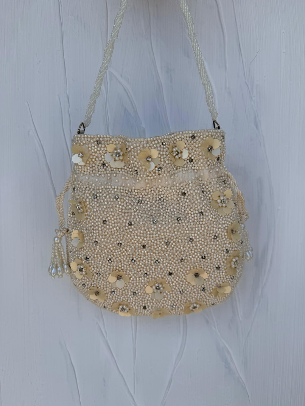 Ivory pearl Indian potli bag back view with 3D floral detail