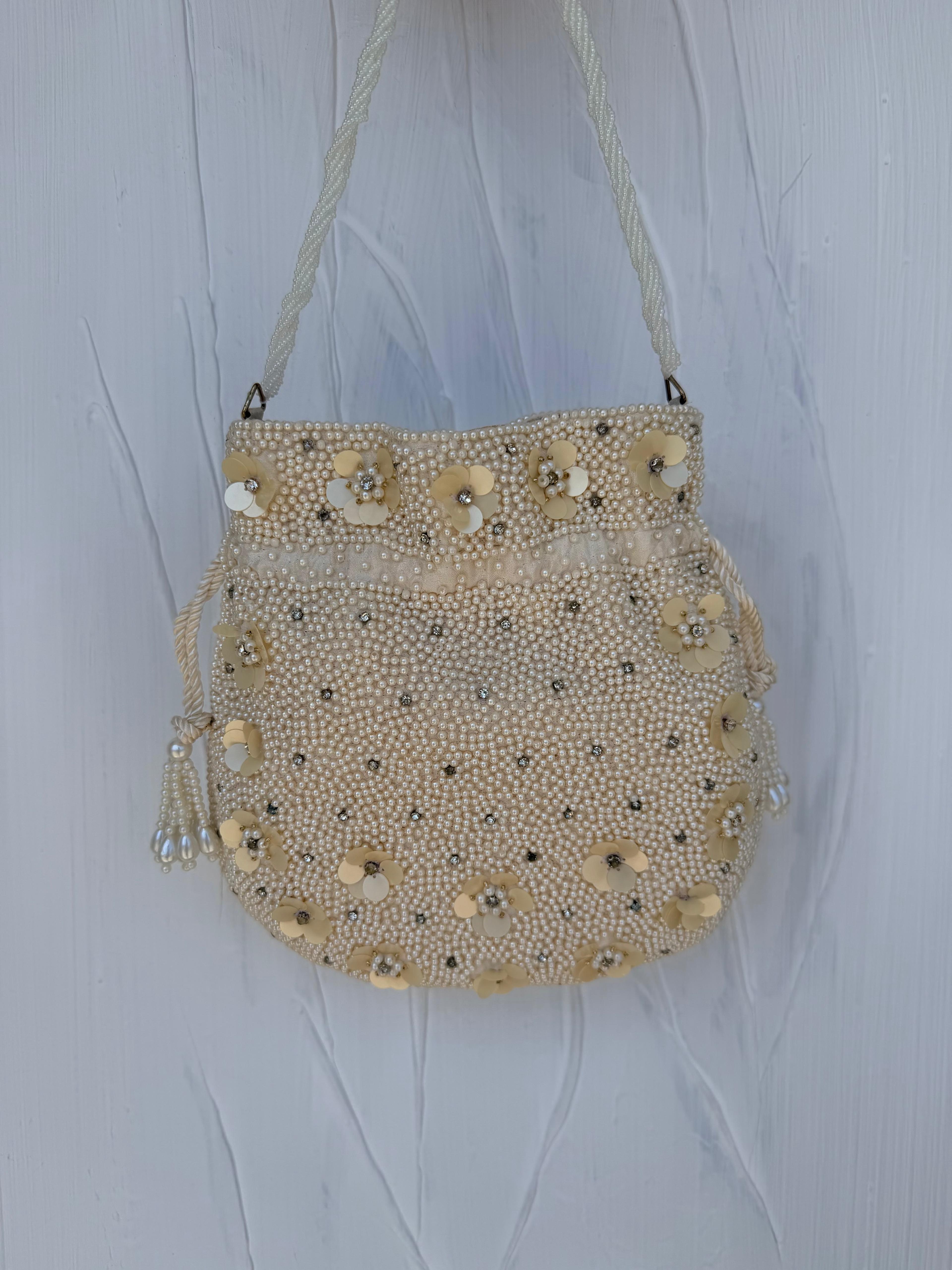 Ivory pearl Indian potli bag back view with 3D floral detail