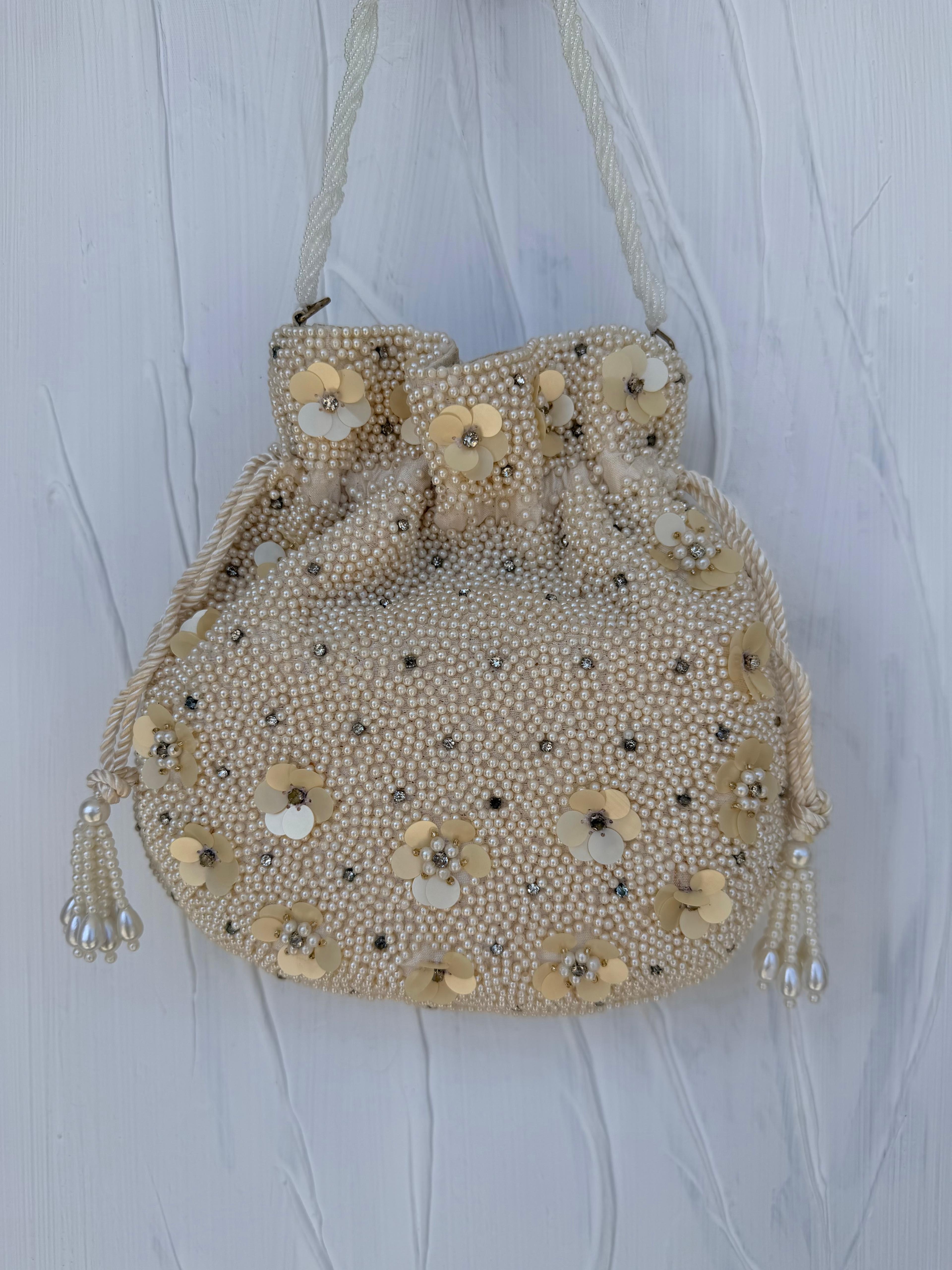 Ivory pearl Indian potli bag with 3D floral sequin detail and tassel drawstring