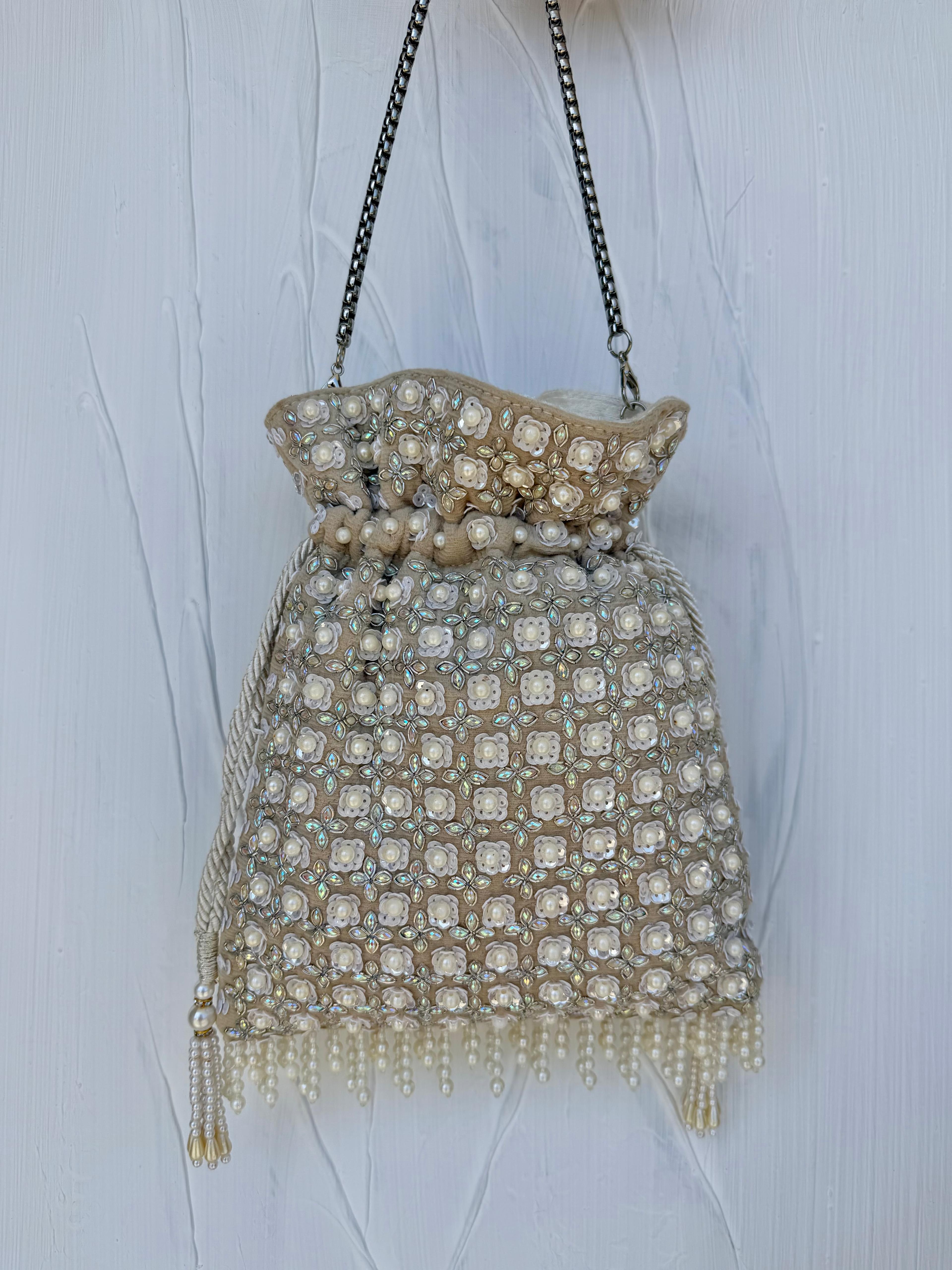White pearl opal potli bag with iridescent sequin detail and chain strap 
